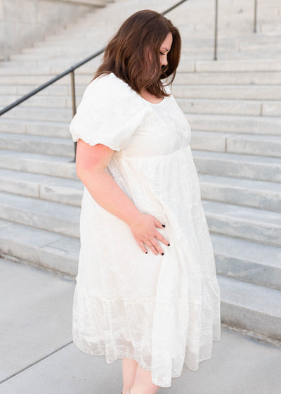 Side view of the plus size white embroidered dress