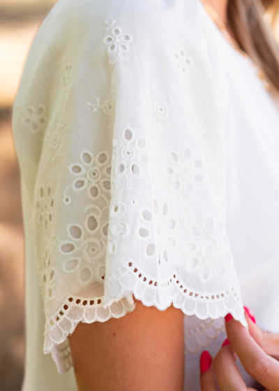 Close up of the sleeve and fabric on the ivory eyelet sleeve dress