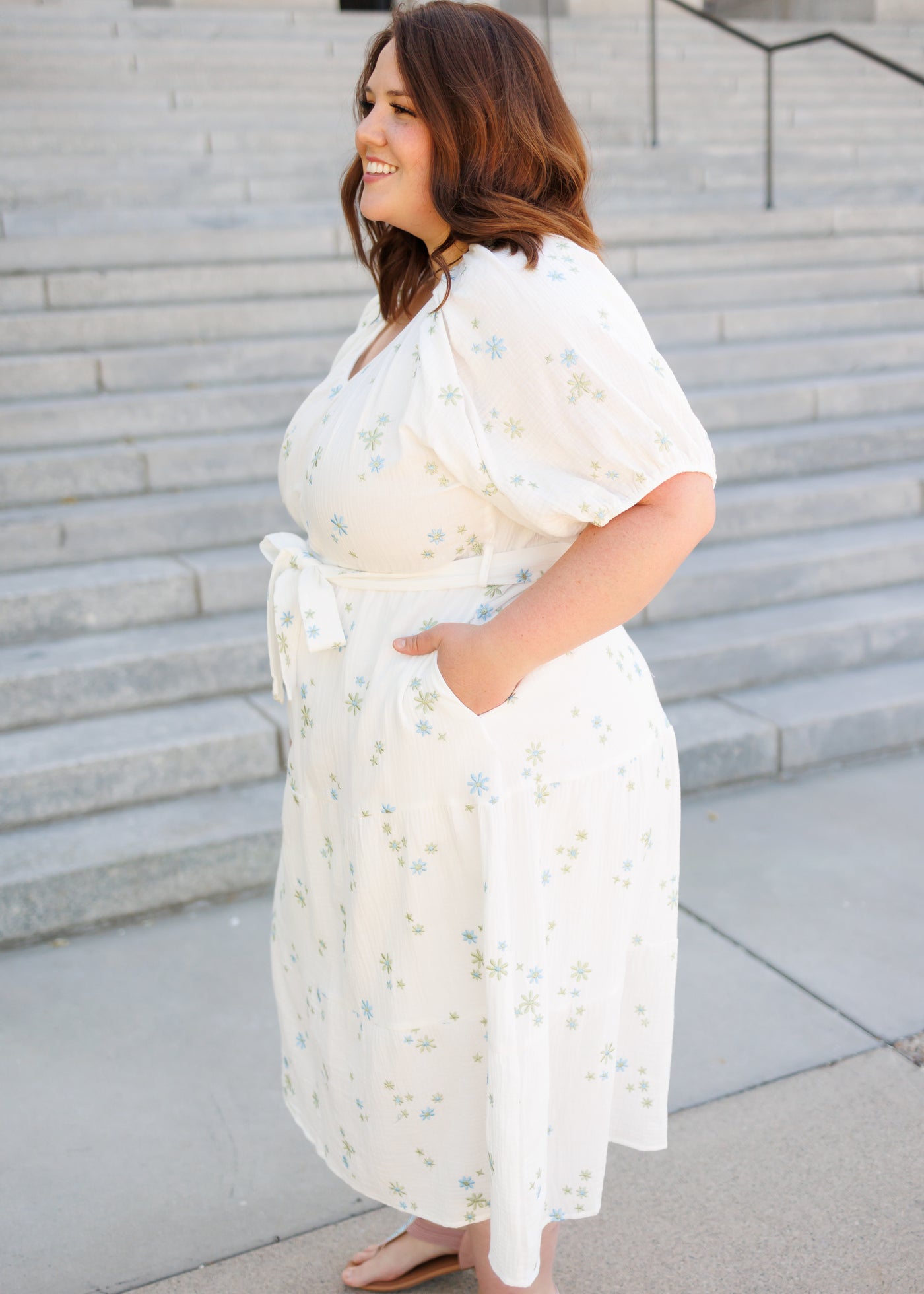 Side view of the white flower embroidered dress in plus size with pockets