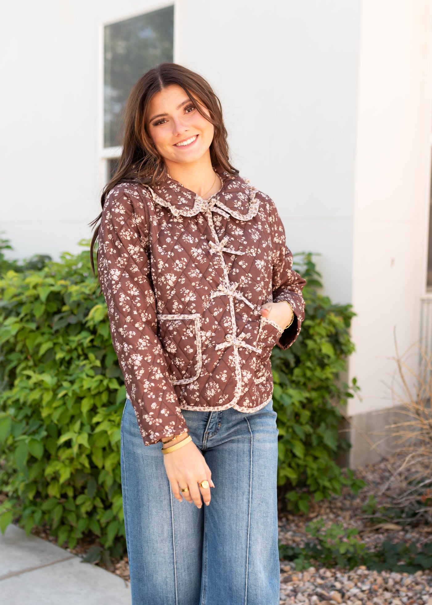 Quilted modest brown floral jacket with long sleeves and bow detail