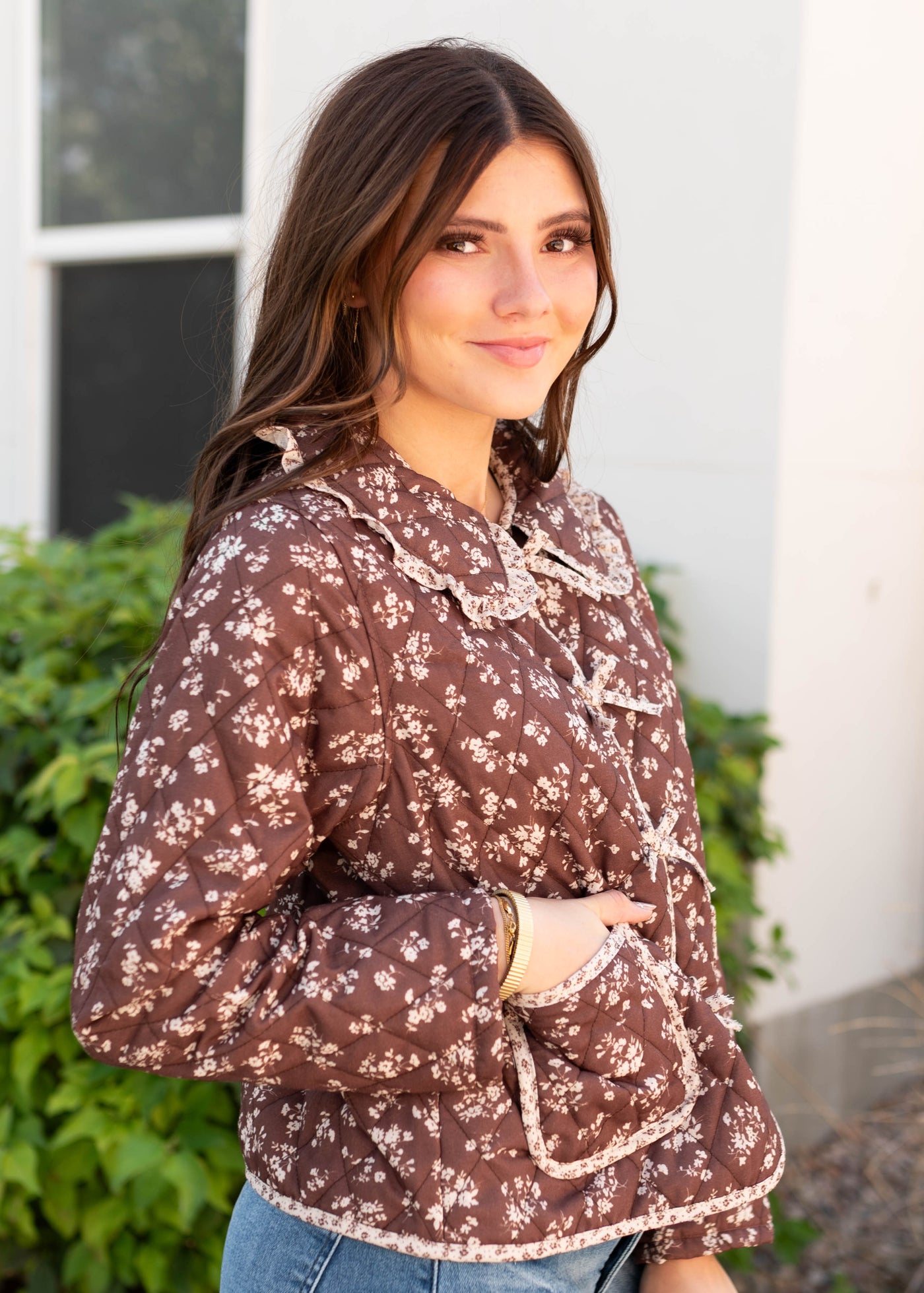 Side view of the brown floral jacket with  two front pockets