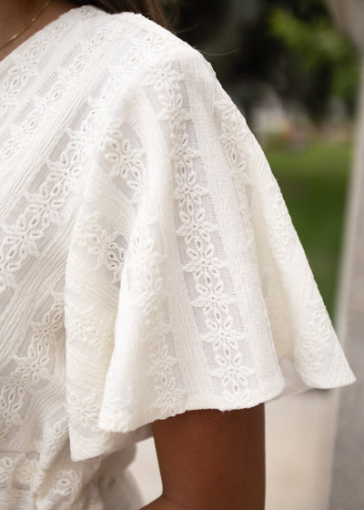 Close up of the sleeve and fabric on the ivory texture tie dress