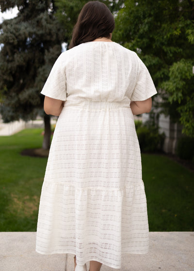 Back view of the ivory textured tie dress in plus size