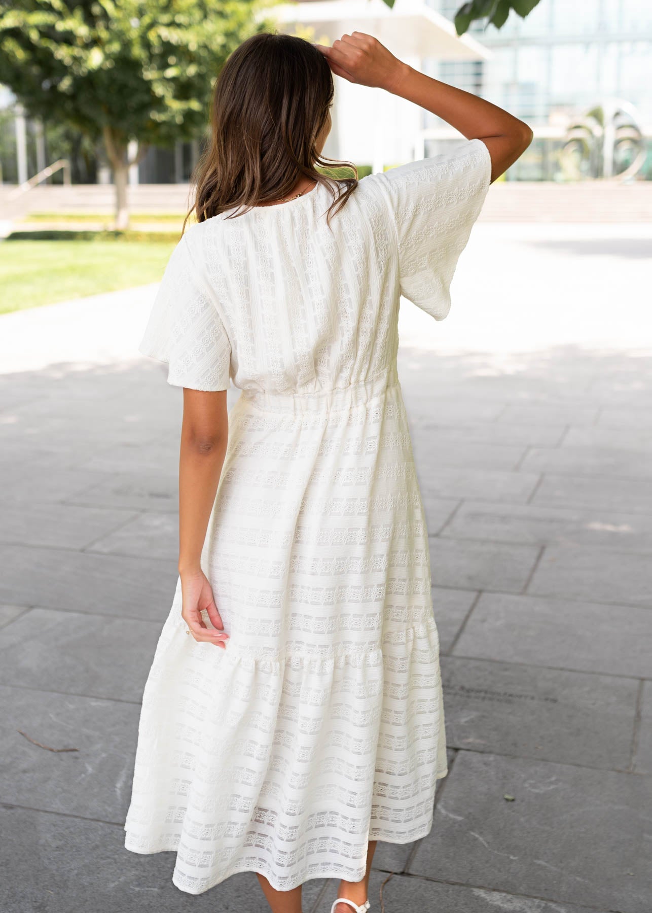 Back view of the ivory textured tie dress
