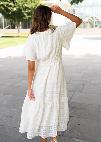 Back view of the ivory textured tie dress