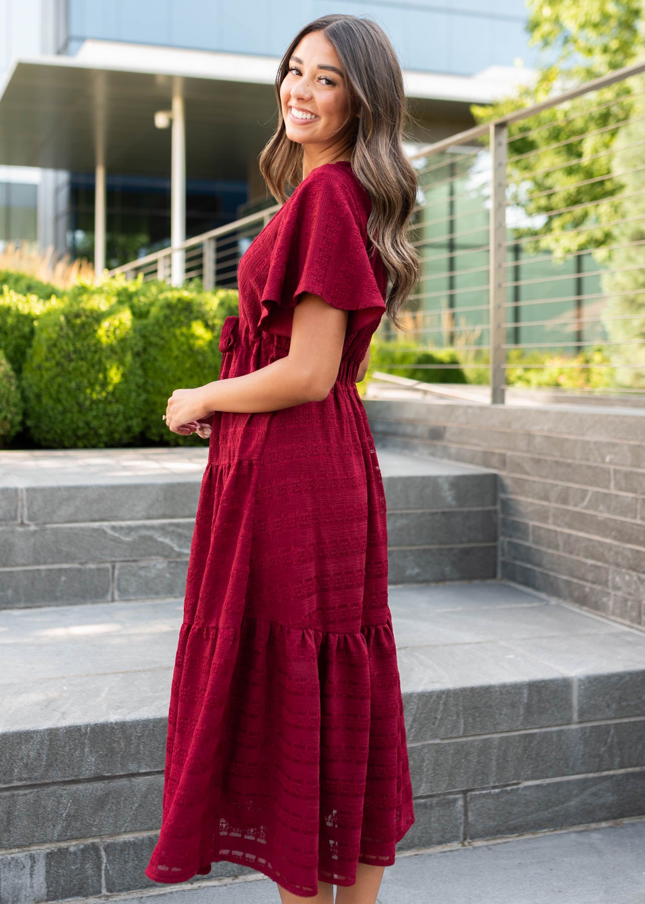 Side view of the modest maroon textured tie dress