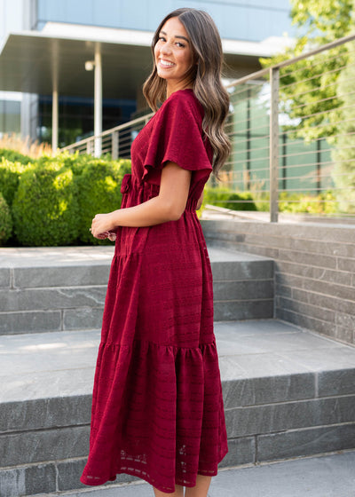 Side view of the modest maroon textured tie dress