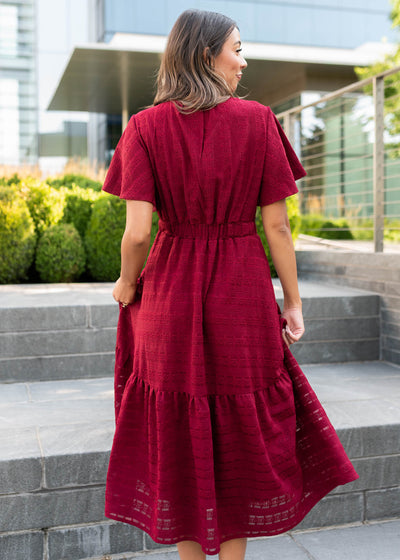 Back view of the maroon textured tie dress