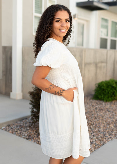 Side view of the white embroidered dress with pockets