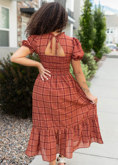 Back view of the brick red plaid dress with a cut out in the back