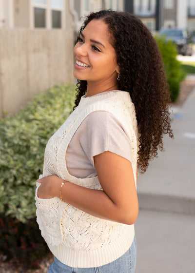 Side view of the cream knit weater vest