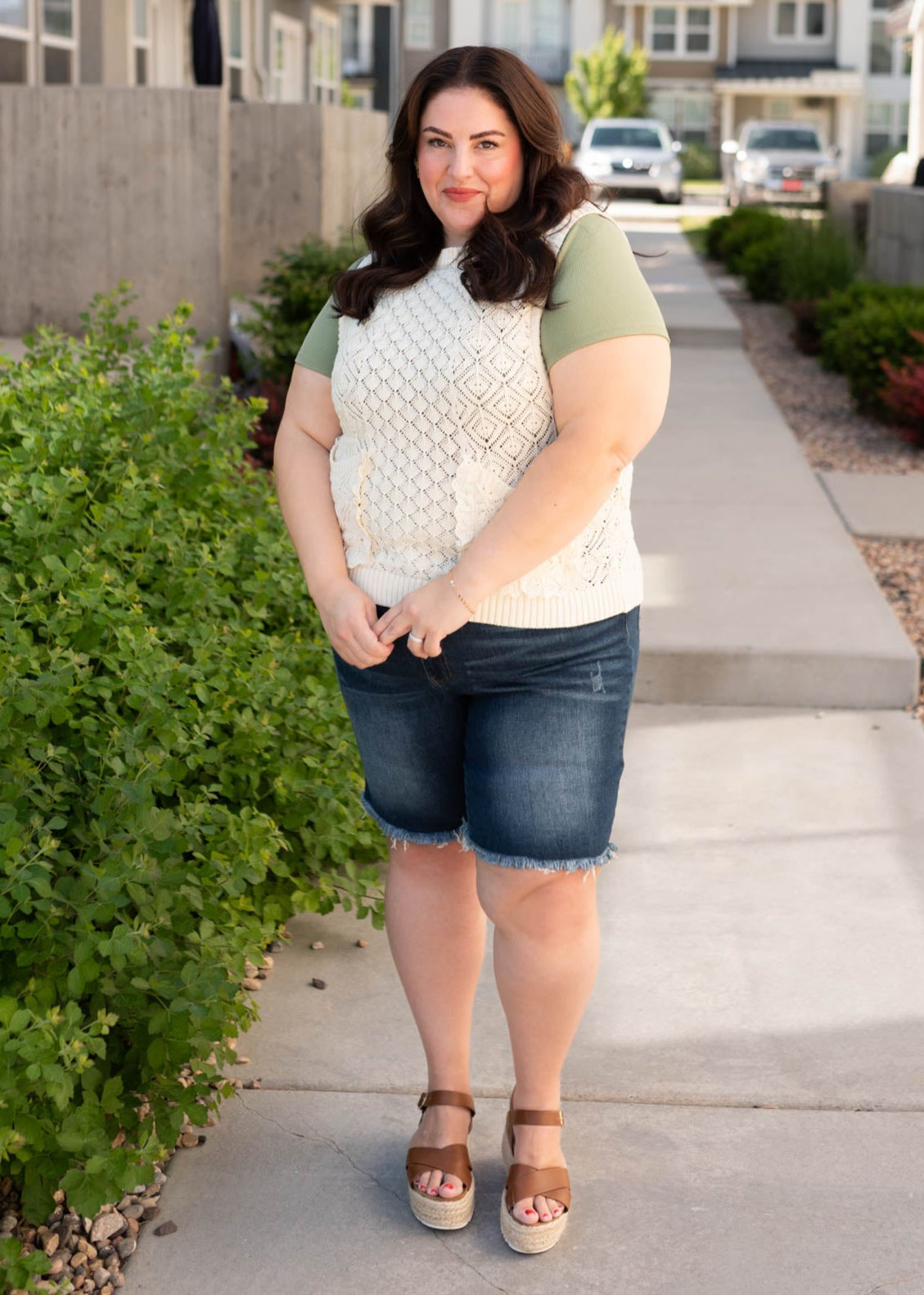 Cream knit sweater vest with lace around the pockets