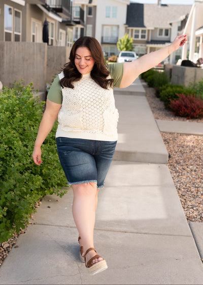 Plus size cream knit sweater vest with front pockets