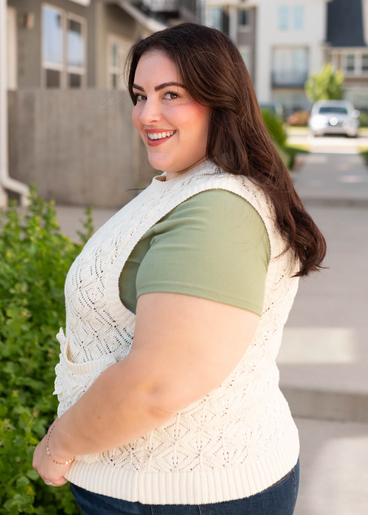 Side view of the plus size cream knit sweater vest