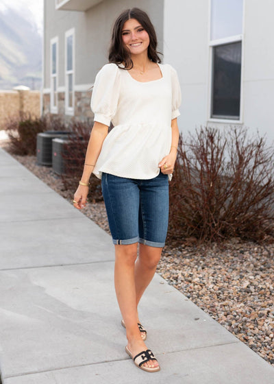 Textured fabric on the cream ruffle top