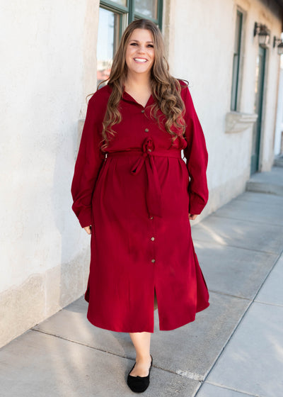 Long sleeve burgundy button up dress with a tie at the waist in plus size