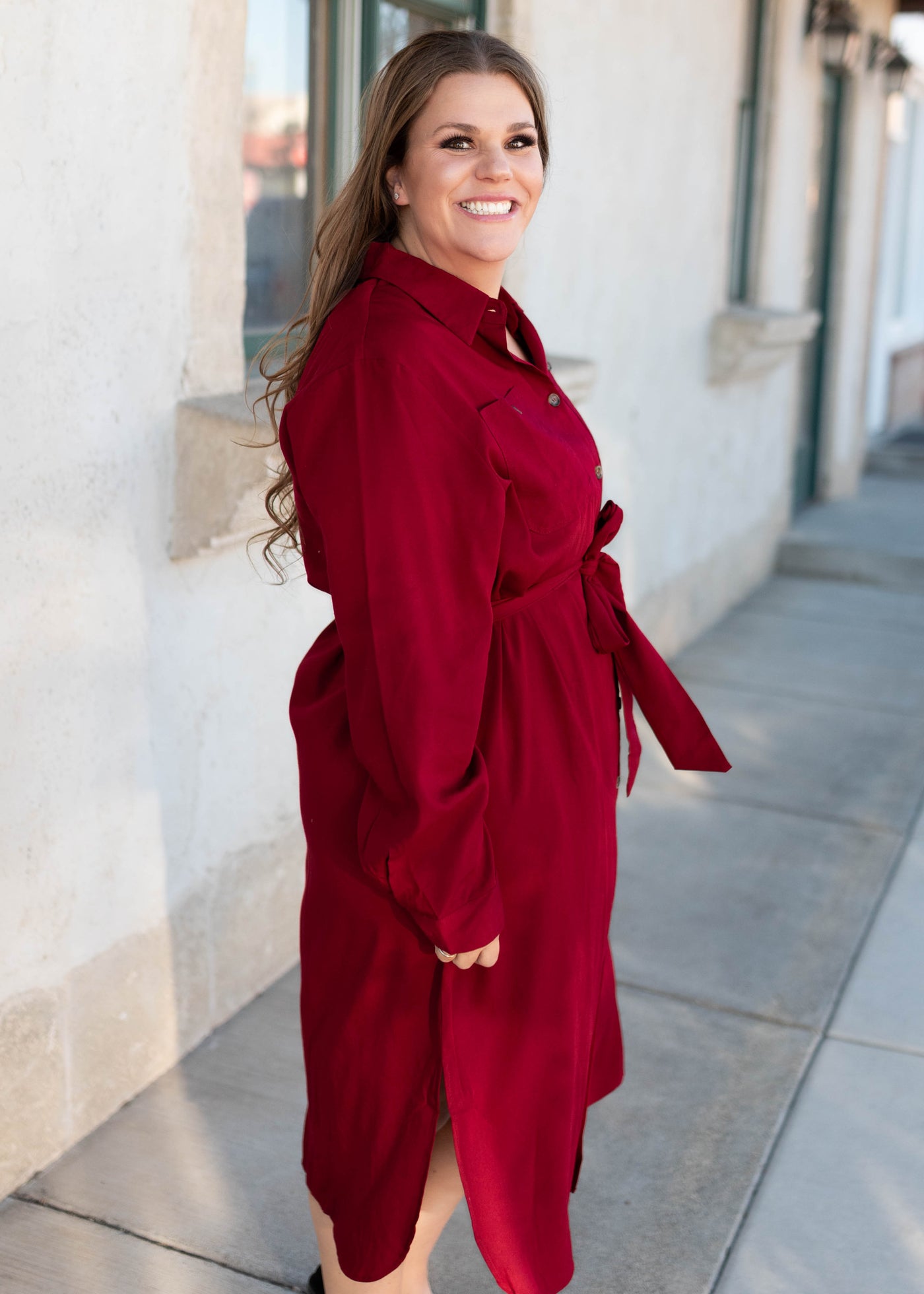 Side view of the plus size burgundy button up dress