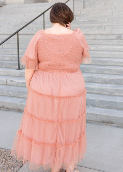 Back view of the dusty coral dress with a smocked bodice in plus size