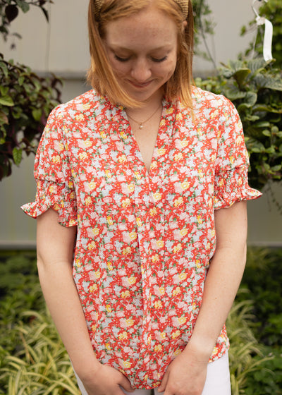 Front of a red short sleeve top with elastic at the sleeves
