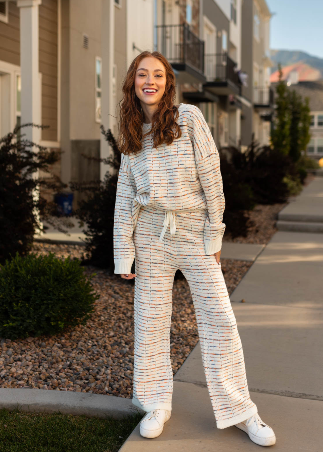 Long sleeve ivory sweater with long ivory pants that tie at the waist that are sold separately