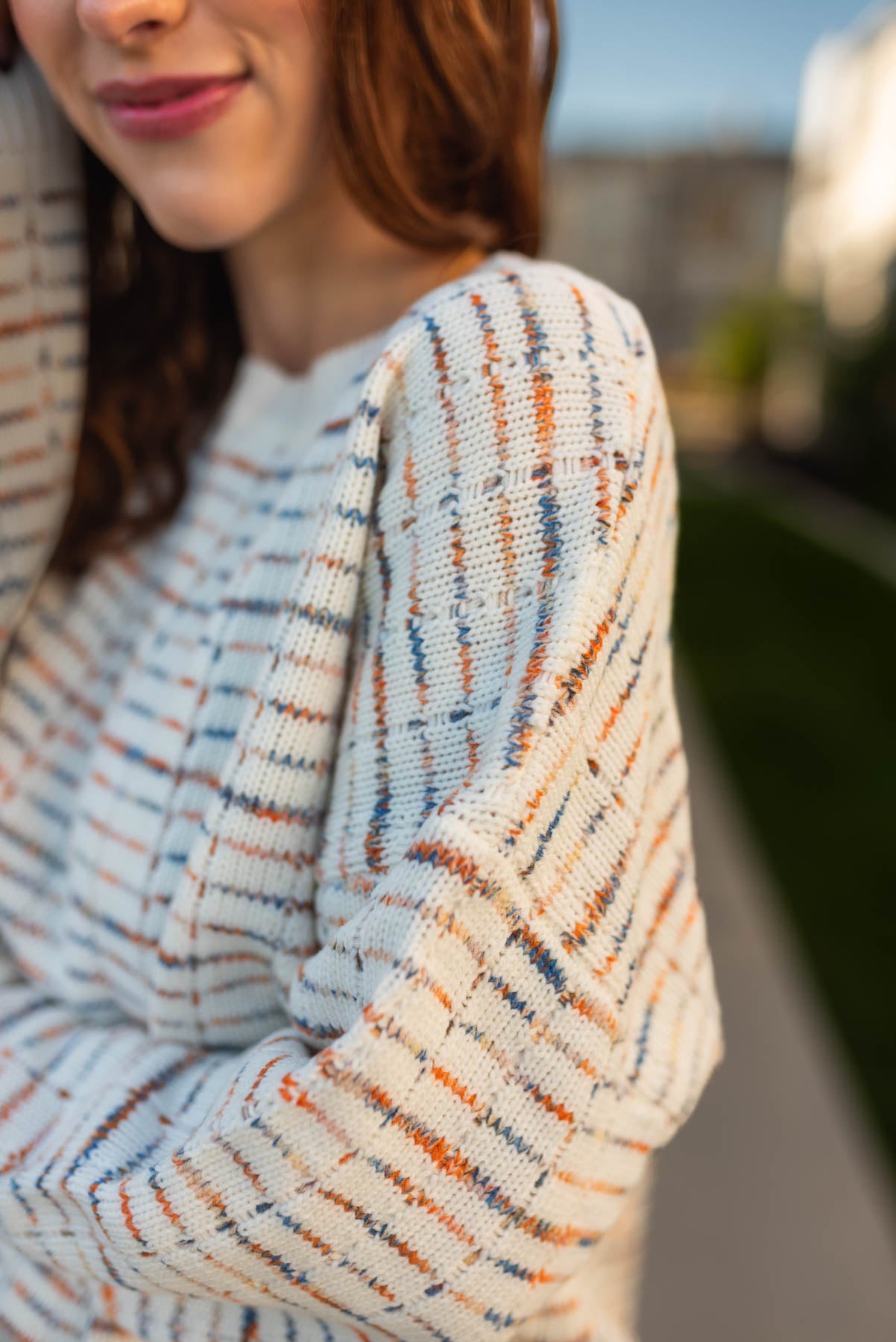 Side view of a ivory sweater