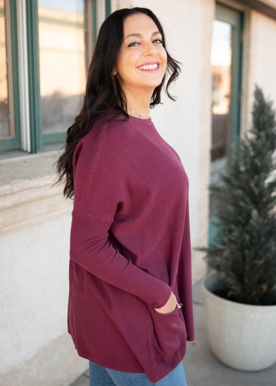 Side view of the burgundy pocket sweater