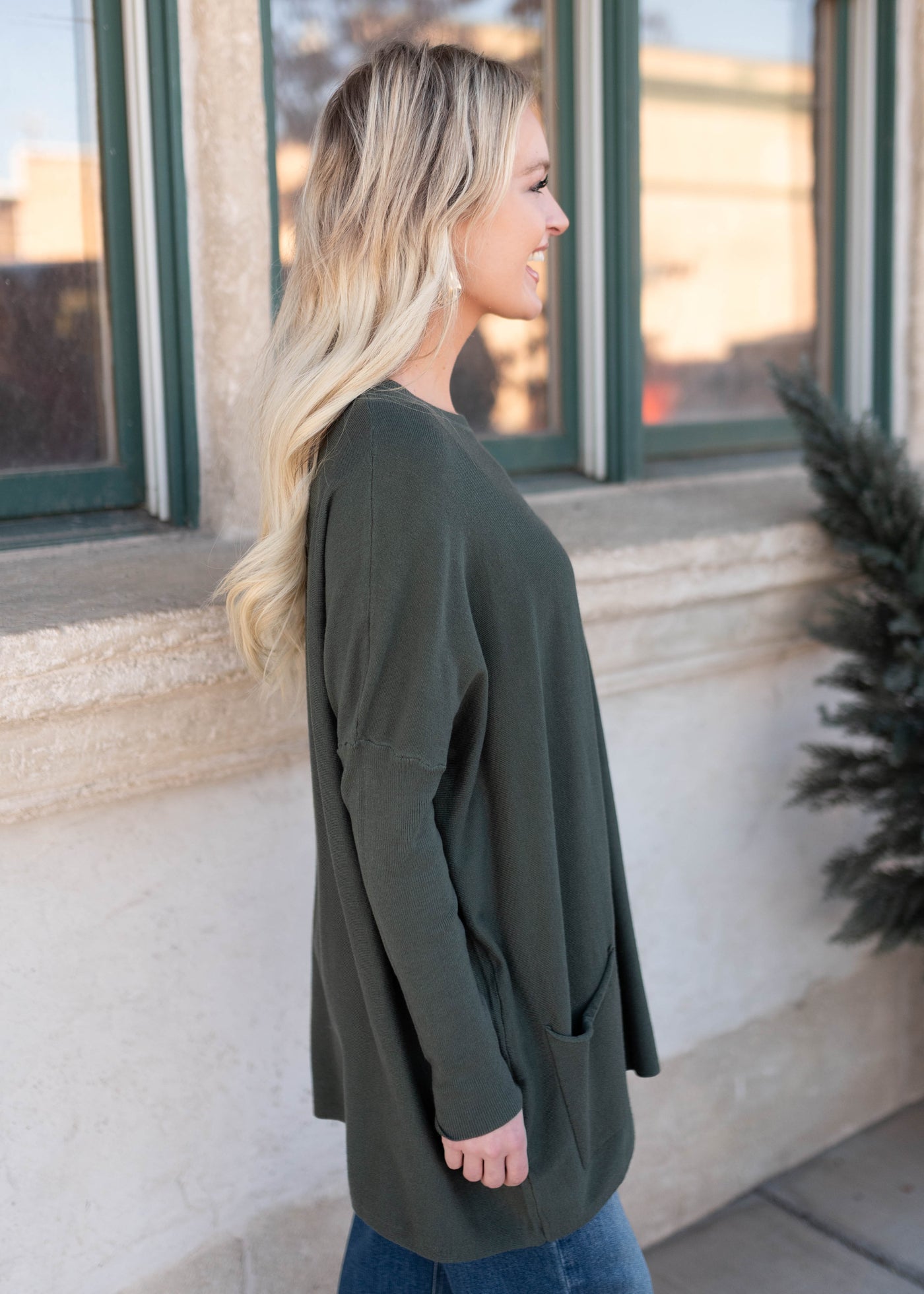 Side view of the green pocket sweater
