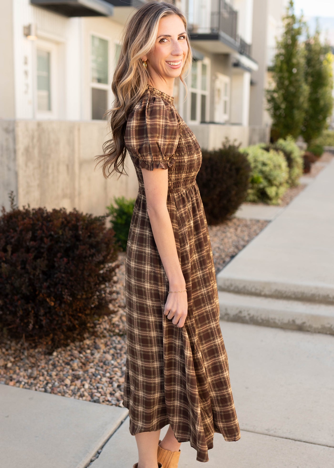 Side view of the modest brown gingham smocked dress