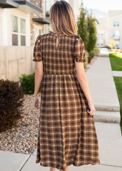 Back view of the brown gingham smocked dress with keyhole closer
