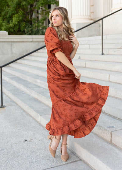 Tiered skirt on the sienna smocked dress with short sleeves and ruffle at the hem by Lena & Lou