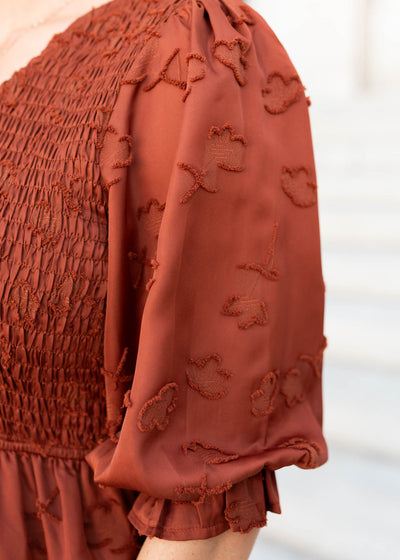 Close up of the sleeve and fabric on the sienna smocked dress