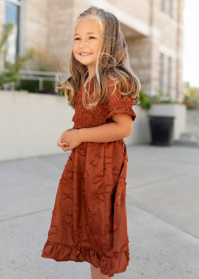 Side view of the modest sienna smocked little girl dress with short sleeves