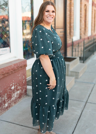 Side view of the dark teal floral dress with ivory embroidered flowers in plus size