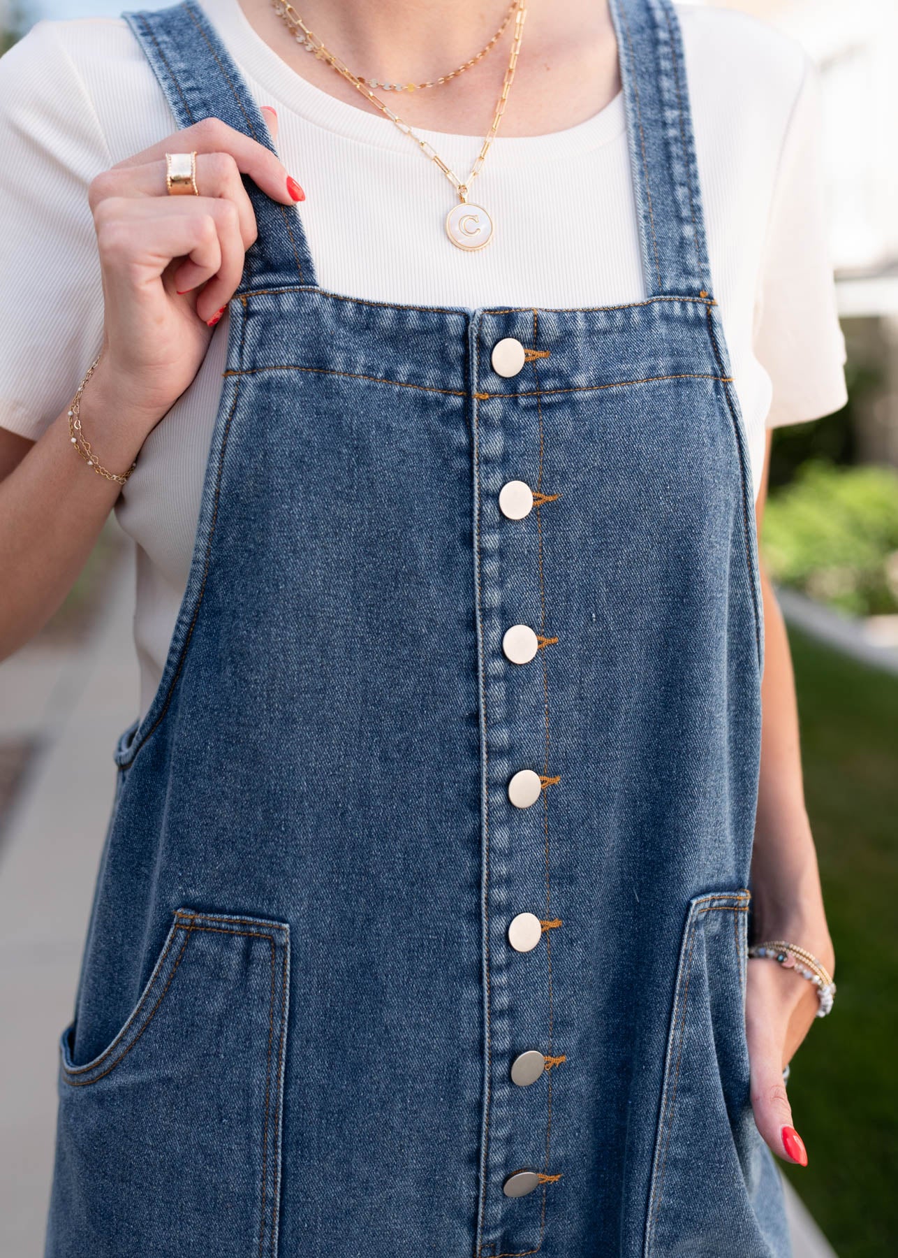 Close up of the buttons on the denim overalls