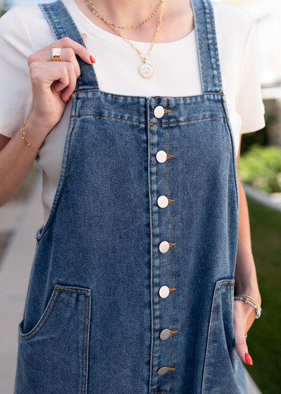 Close up of the buttons on the denim overalls
