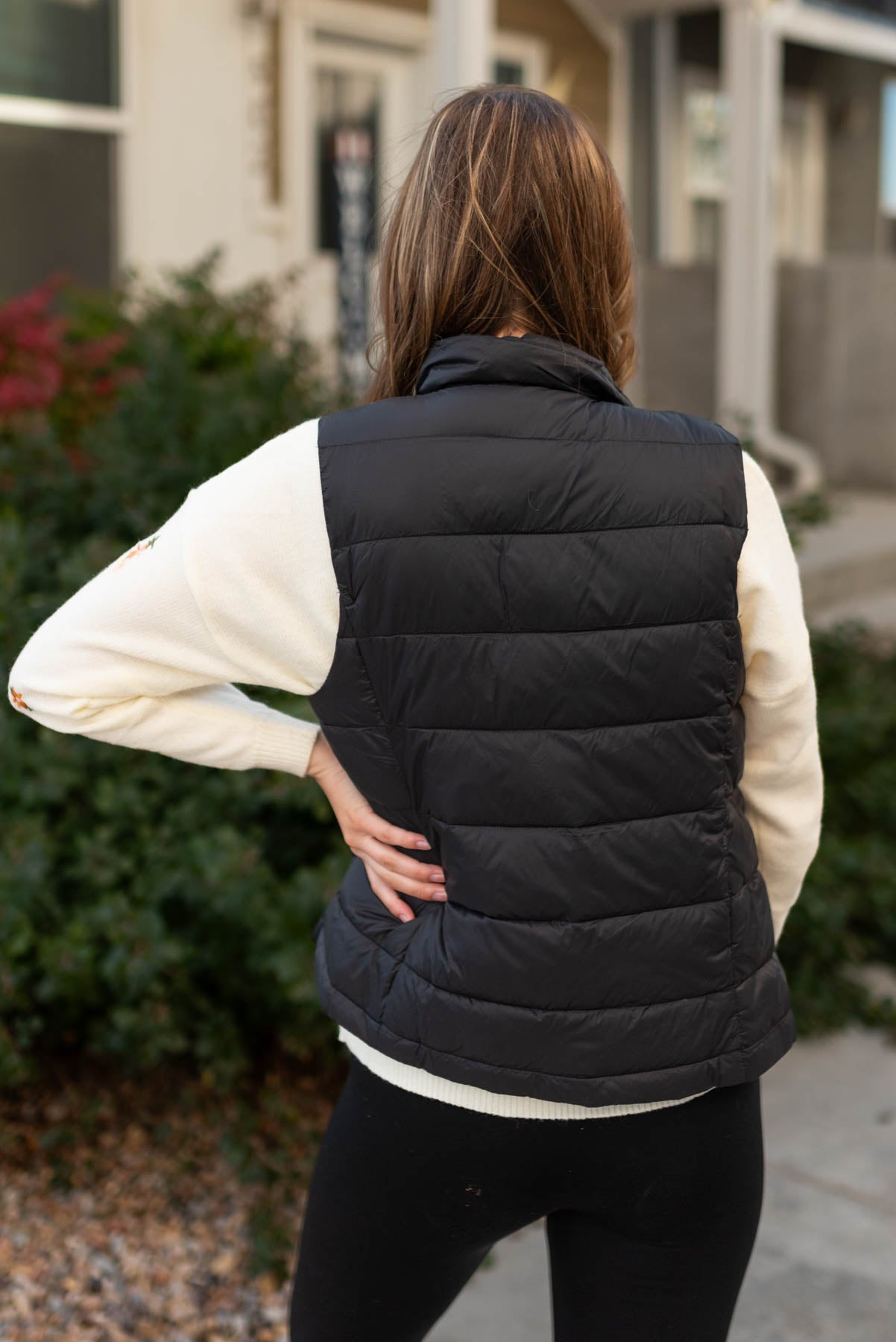 Back view of a black puff vest
