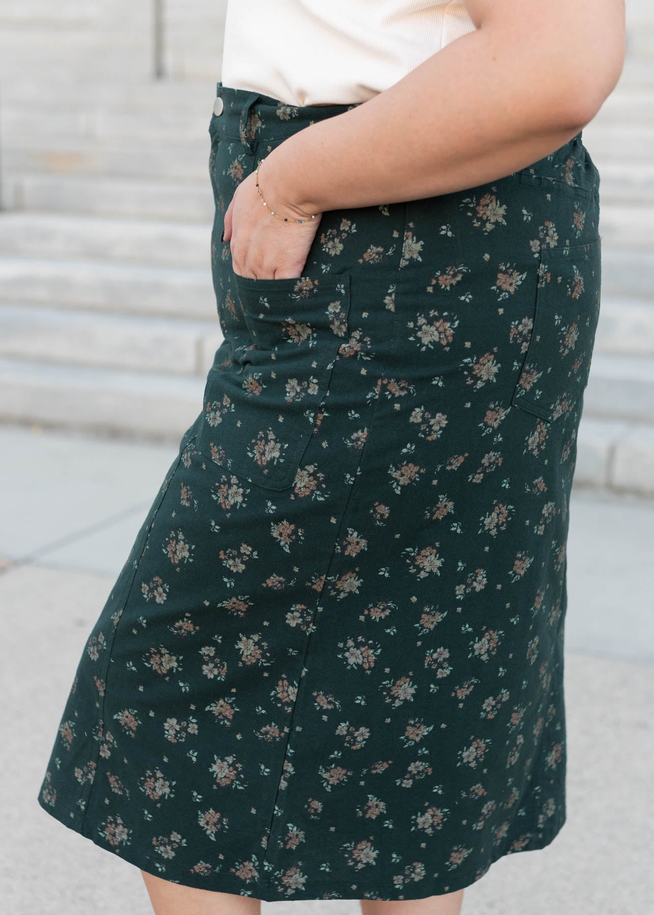 Side view of the modest plus size green floral pencil skirt with pockets