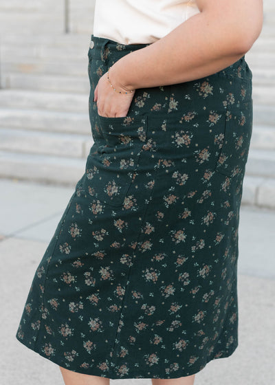 Side view of the modest plus size green floral pencil skirt with pockets
