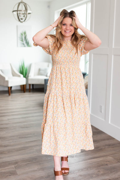Short sleeve peach floral dress with smocked bodice and tiered skirt