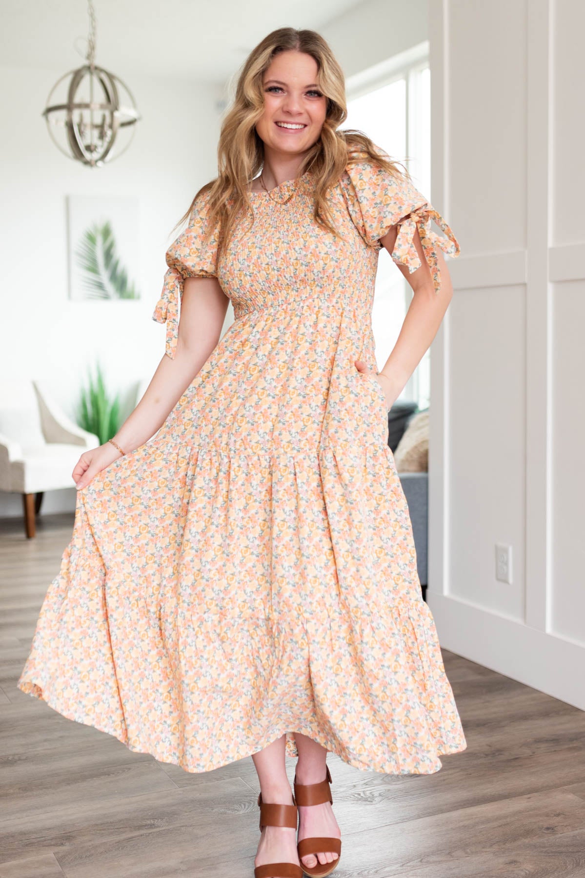 Peach floral dress with pockets and a tiered skirt