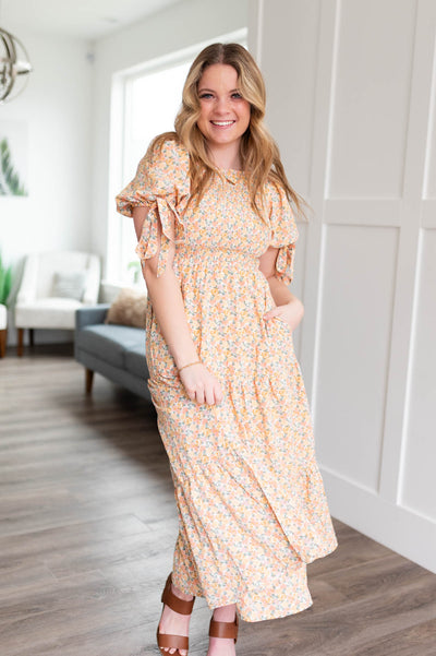 Short sleeve peach floral dress with smocked bodice