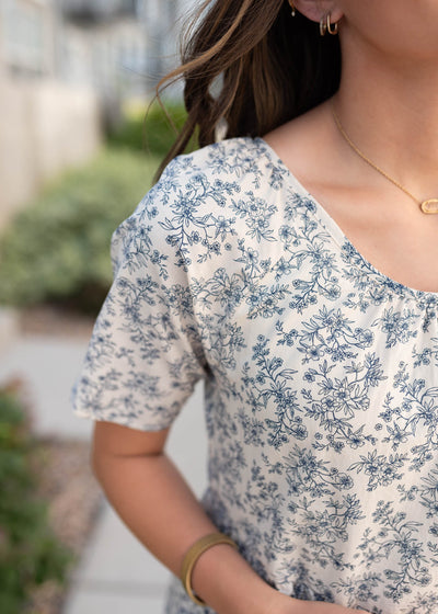 Cream floral tiered dress with blue flowers