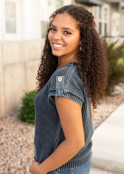 Side view of the modest navy knit sweater with button on the shoulder