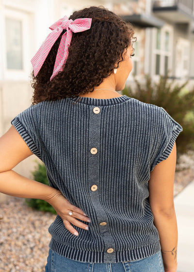 Back view of the navy knit sweater with buttons up the back