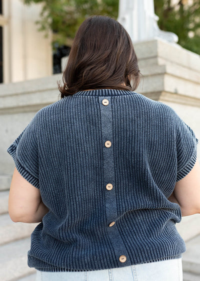 Back view of the navy knit sweater with buttons up the back
