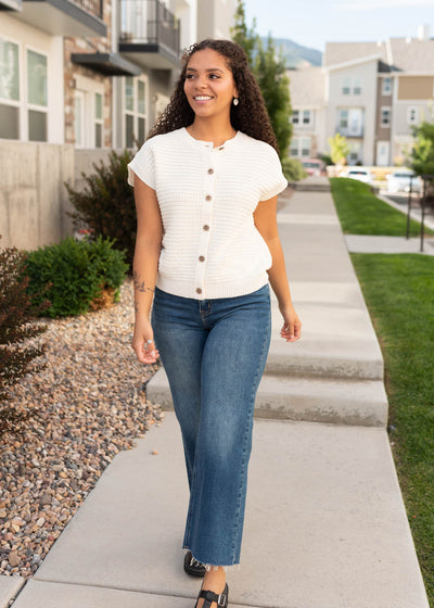 Size small to large in the cream button down sweater