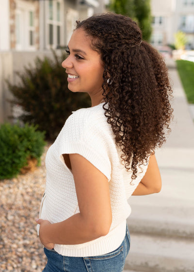 Side view of the cream button down sweater