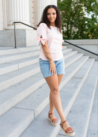 Pink bow top with bows on the sleeves