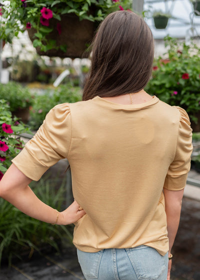 Back view of the light tan ruffle sleeve top