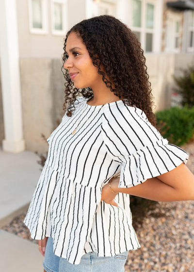 Side view of the black striped peplum top